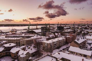 Obraz premium Aerial view of Klaipeda city port area and it's surroundings on sunny winter evening. The Old town of Klaipeda, Lithuania in evening light at wintertime.