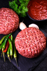 ingredients for making hamburger. fresh ground meat with seasonings. fresh vegetables.