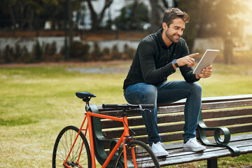 Bike, tablet and relax with man in park for communication, social media or connection. Networking,...
