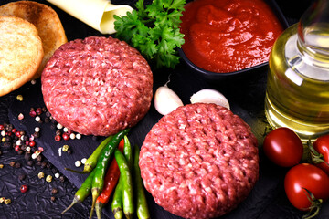 ingredients for making hamburger. fresh ground meat with seasonings. fresh vegetables.