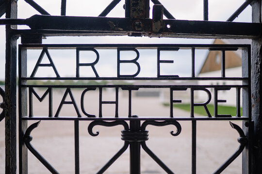 Munich, Germany - September 13, 2024 - Close-up of the &ldquo;Arbeit Macht Frei&rdquo; sign on the entrance gate to Dachau Concentration Camp Memorial, symbolizing historical significance..