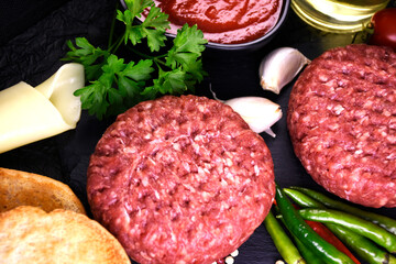 ingredients for making hamburger. fresh ground meat with seasonings. fresh vegetables.