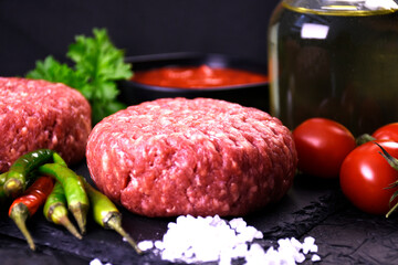 ingredients for making hamburger. fresh ground meat with seasonings. fresh vegetables.