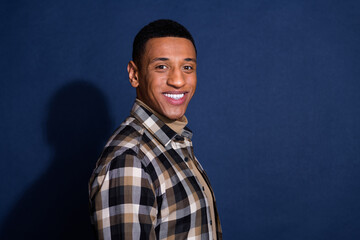 Obraz premium Photo portrait of handsome young man look camera cheerful dressed stylish plaid garment isolated on dark blue color background