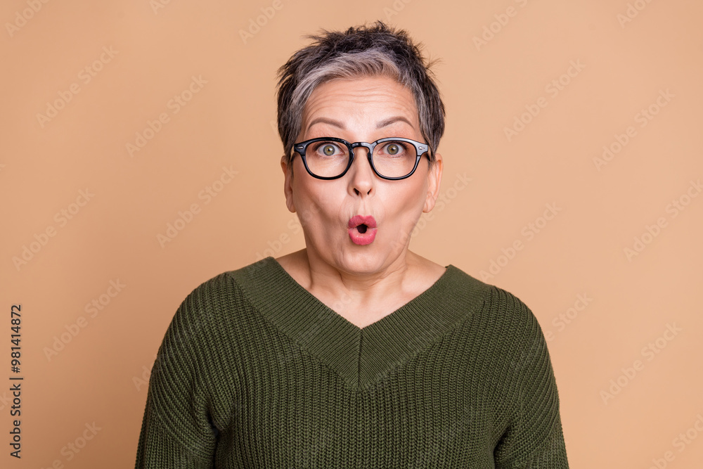 Canvas Prints Photo of speechless woman with short hairdo dressed khaki knit sweater in glasses astonished staring isolated on beige color background