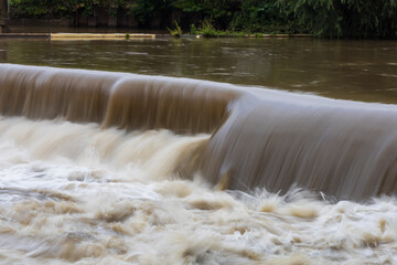 Weir on the Svitava River in the city of Brno, a local part of the Obrany. Big water after rain.