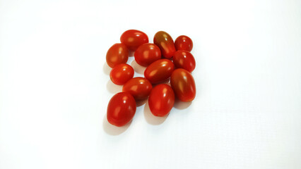 Some cherry tomatoes on the white background with copy space.
