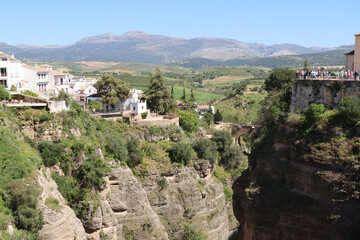 Tourists admiring ronda spain landscape from puente nuevo bridge