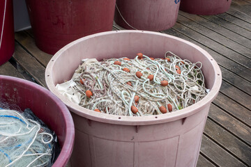 view of several buckets with fishing nets on a boat
