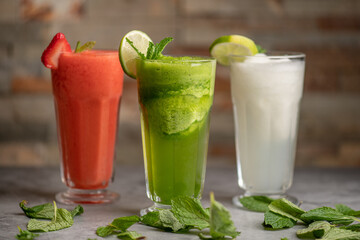 Three drinks: lemonade, strawberry and green juice