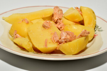 On the plate are potatoes with meat, ready to eat.