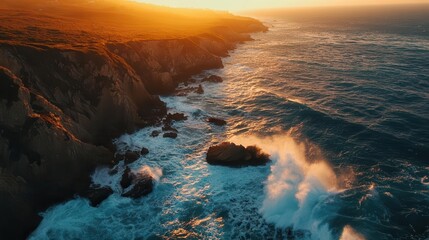 Fototapeta premium aerial view of turquoise waves crashing against rugged cliffs at sunset golden light illuminates rocky coastline creating dramatic shadows and vibrant colors