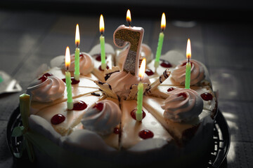 Number seven on the cake. Festive cake with candles. Child's seventh birthday