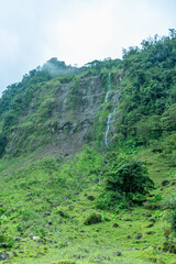 Beautiful landscape in the green Andes Mountains. Forest, waterfall. blue sky. Jard&iacute;n, Antioquia, Colombia.