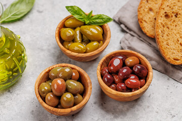 An assortment of various olives presented in a bowl, showcasing different colors, textures, and flavors