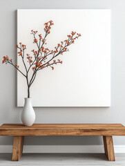 A white vase with a branch of orange flowers sits on a wooden bench.