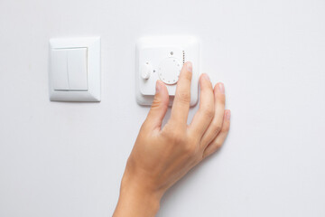 Woman adjusting lighting with dimmer lever, closeup. An electronic device designed to change electrical power