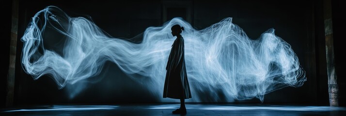 Silhouette of an individual in a long coat is framed by swirling light trails, creating a captivating manifestation of creativity and ambiance
