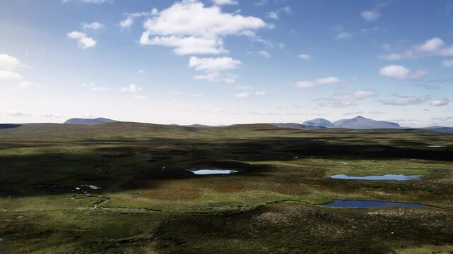 Rising Drone as the camera zooms in on Norwegian mountains of Skarsfjella og Hyllingsdalen and the expansive Flatruet high fell plateau, showcasing ponds and heathland in j&auml;mtland, h&auml;rjedalen Sweden
