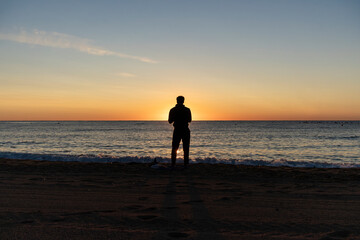 couple walking on the beach at sunset