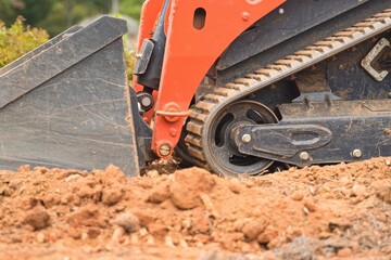 Orange construction vehicle sitting in a construction zone