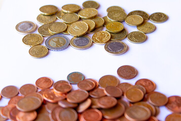 euro coins on a white background, facing each other in two blocks suggesting the concept of competitiveness
