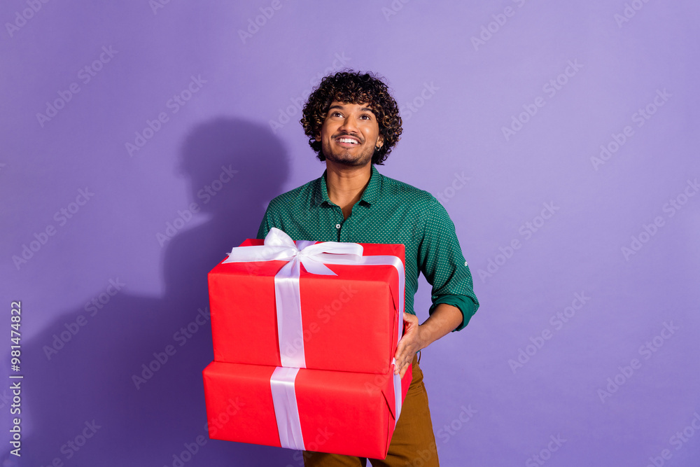 Sticker Photo of mexican guy with wavy haircut wearing casual shirt preparing surprises looking up for holiday isolated on violet color background