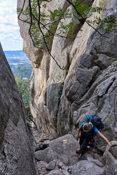 Hikers climbing among rocks following a trail