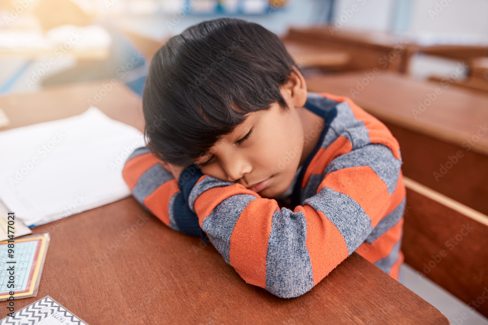 Poster desk, exhausted and sleeping with boy student in classroom at school for child development or learni