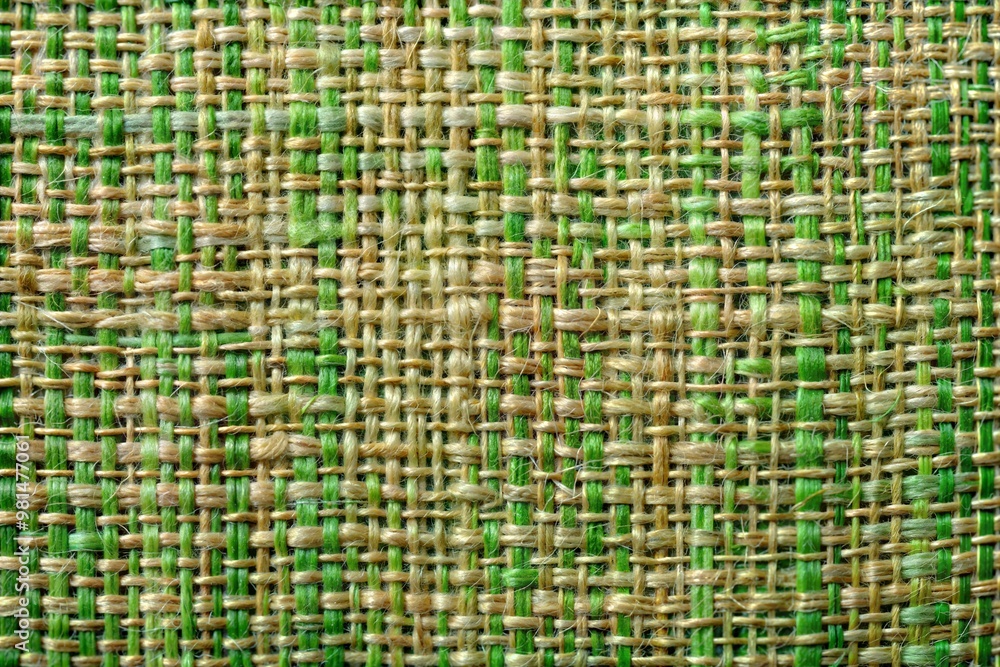 Sticker Woven fabric texture with green and tan threads close-up