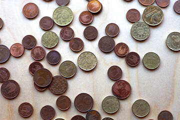 coins on a wooden surface, top view.
