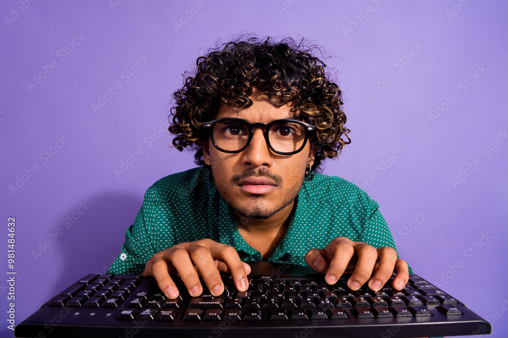 Poster closeup photo of arabian guy working programmer addicted looking in pc screen using keyboard wearing
