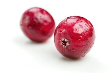 Obraz premium Two juicy pomegranates on a white background, perfect for food and nature photography