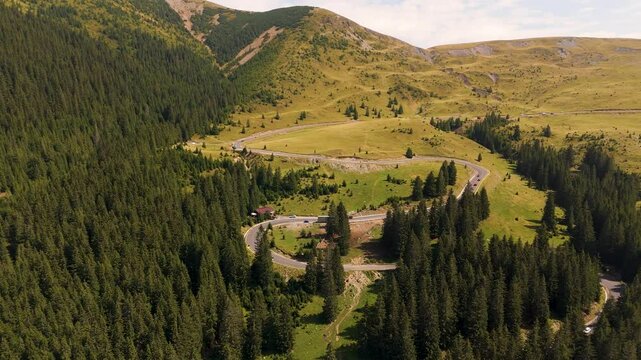 Aerial view of the Carpathian Mountains in Romania. Transalpina. Drone video of one of the most iconic roads in Romania called Transalpina Road. Parang mountains. Top cinematic aerial view