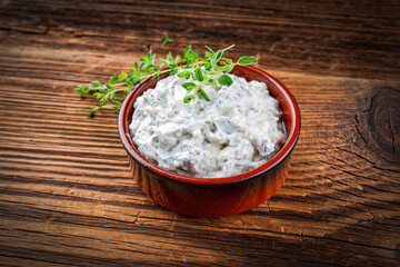 Traditional Italian Obatzda with camembert and mascarpone served with garlic and spring onion as a close-up in a bowl
