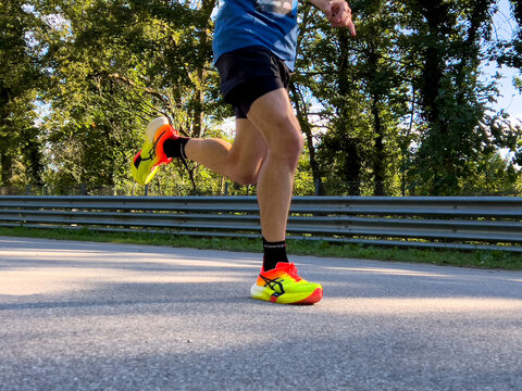 Monza, Italy - September 15, 2024: legs runner athlete in Asics running shoes during Monza21 half marathon