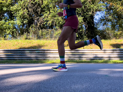 Monza, Italy - September 15, 2024: legs runner athlete in Hoka running shoes during Monza21 half marathon