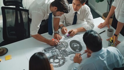 Top view of professional engineer showing and talking about turbine engine design. Aerial view of...