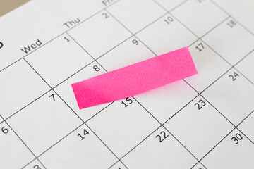 Calendar close up. Blank calendar with pink note sticker