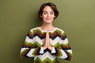 Photo of dreamy adorable girl dressed striped clothes arms together closed eyes enjoying yoga...