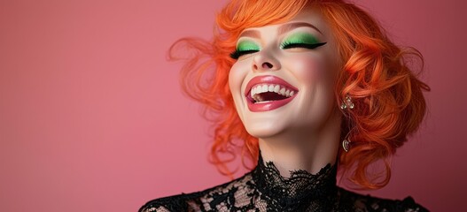 Obraz premium Joyful drag queen with vibrant orange hair and stunning green eyeshadow laughing against a pink background