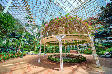 Lush Greenhouse Garden with Gazebo and Water Feature High Angle View