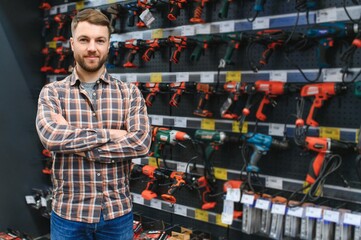 Naklejka premium Young man working in hardware store