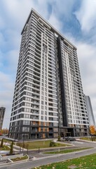 Modern high rise apartment building against clear blue sky for text placement in design projects