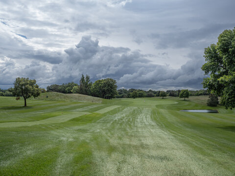 rain clouds over a green fairway on a golf course 