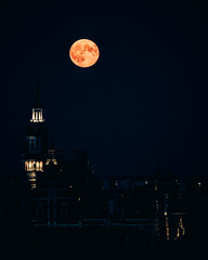 Full moon over a church at night