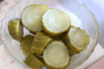 Freshly cut cucumbers arranged in a glass container for serving or decoration