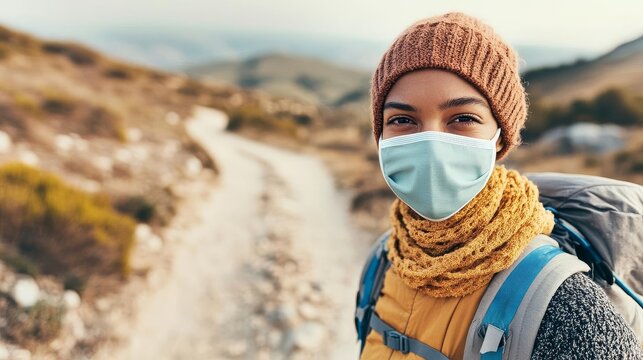 Person wearing a breathable face mask on a dusty trail, rugged terrain ahead, hiking trail gear, protection against dust