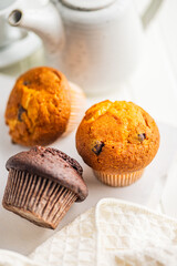 Sweet muffin cakes on white table.