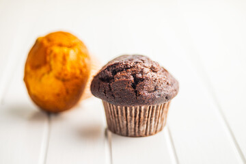 Sweet muffin cakes on white table.